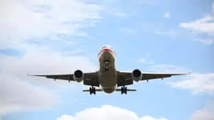Flying Airplane In The Clouds Background
