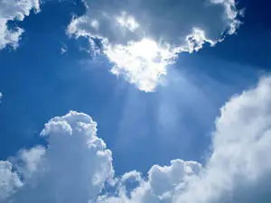 سماء زرقاء مع غيوم وشمس مشرقة