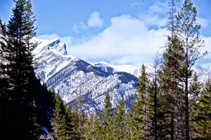 Stand atop a spectacular mountain and take in a breathtaking view of the snow-covered scenery. 