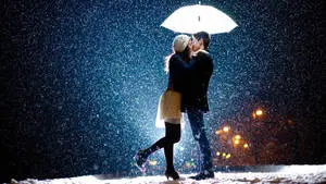 Korean Couple Kissing Amid Snowfall 