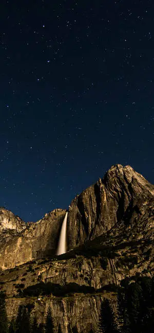 Natural Waterfall From Mountain Night Sky