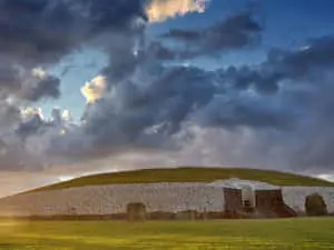 Newgrange With Stormy Clouds And Sunset Lighting
